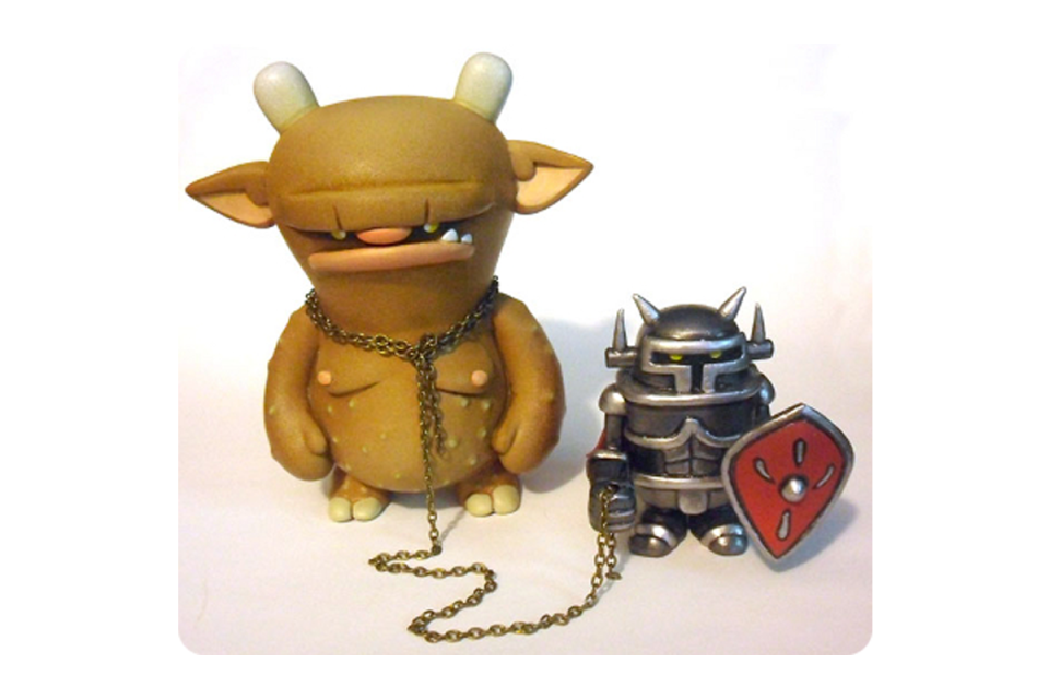 Yellow ochre ogre chained to a armored figure with a red shield